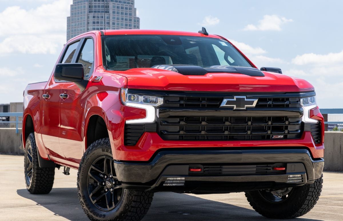 2024 Chevy Silverado, a Chevrolet Certified Pre-Owned vehicle, parked in front of downtown Winston-Salem, NC skyline