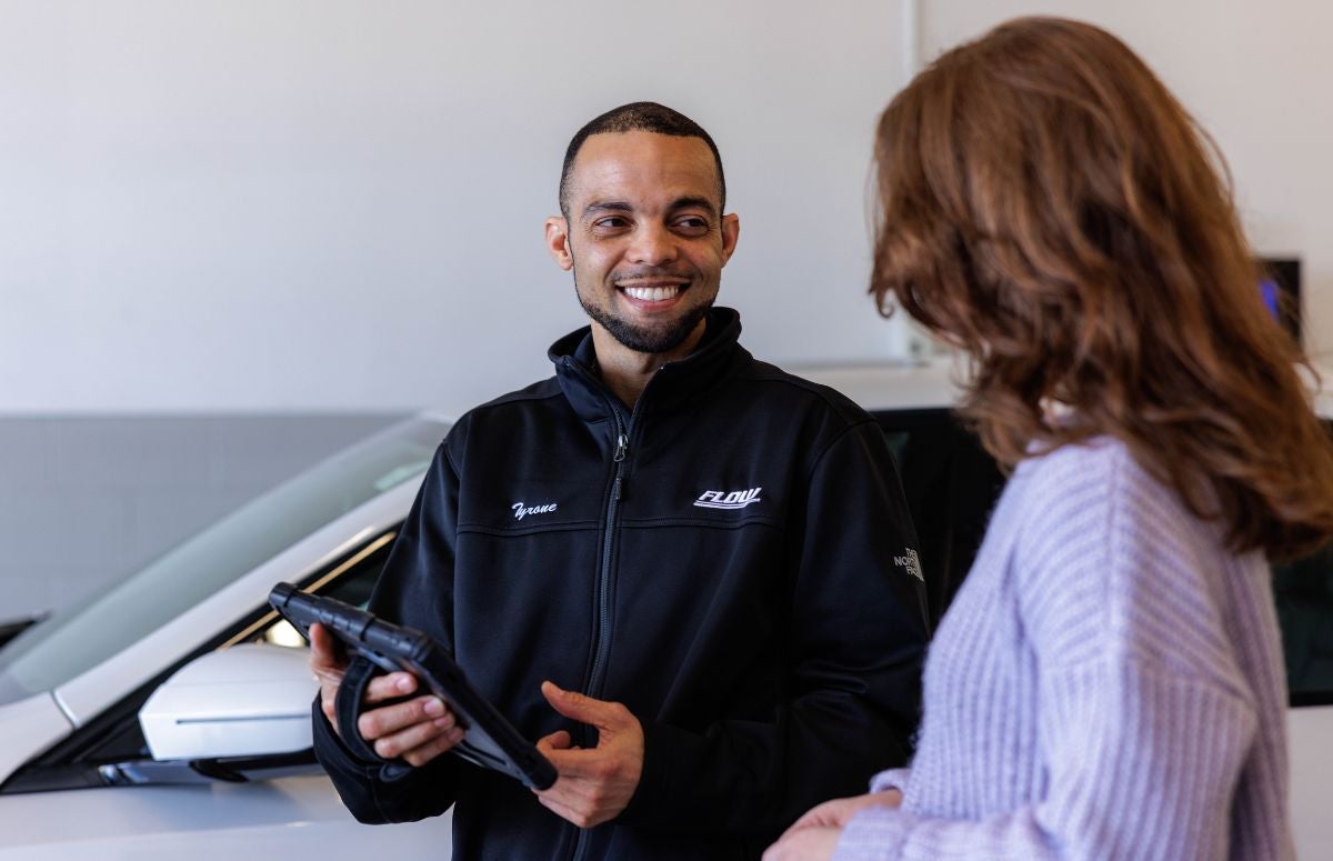 Flow Chevy team member interacting with customer at Chevrolet service center in Winston-Salem
