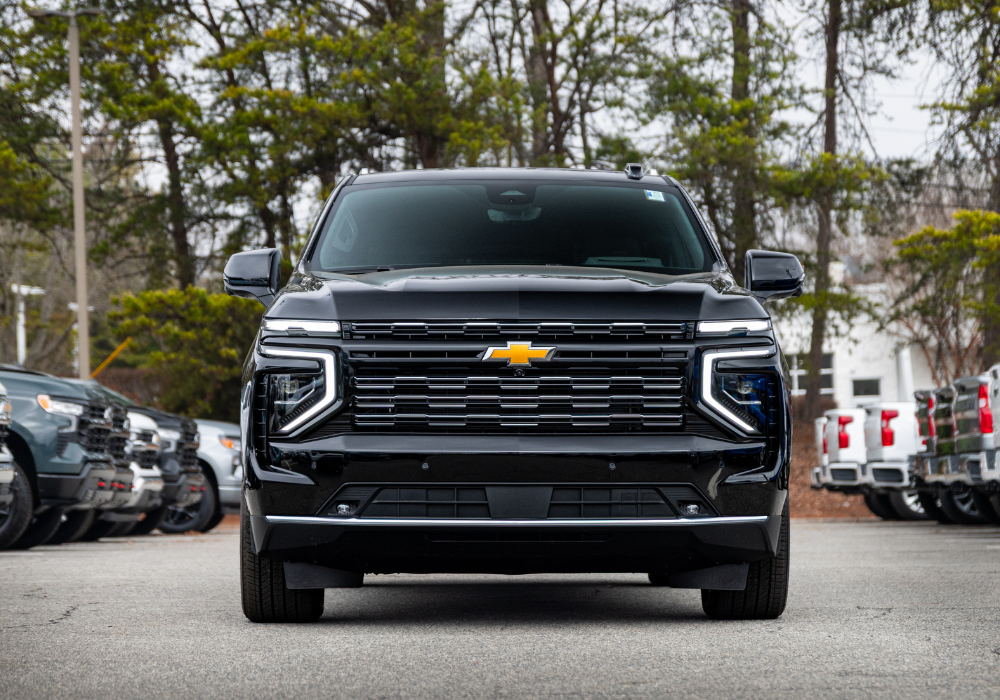 Full on view of the front of a 2026 Chevrolet Suburban SUV in the color black.